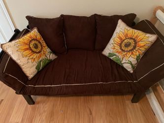 Futon couch with pillows