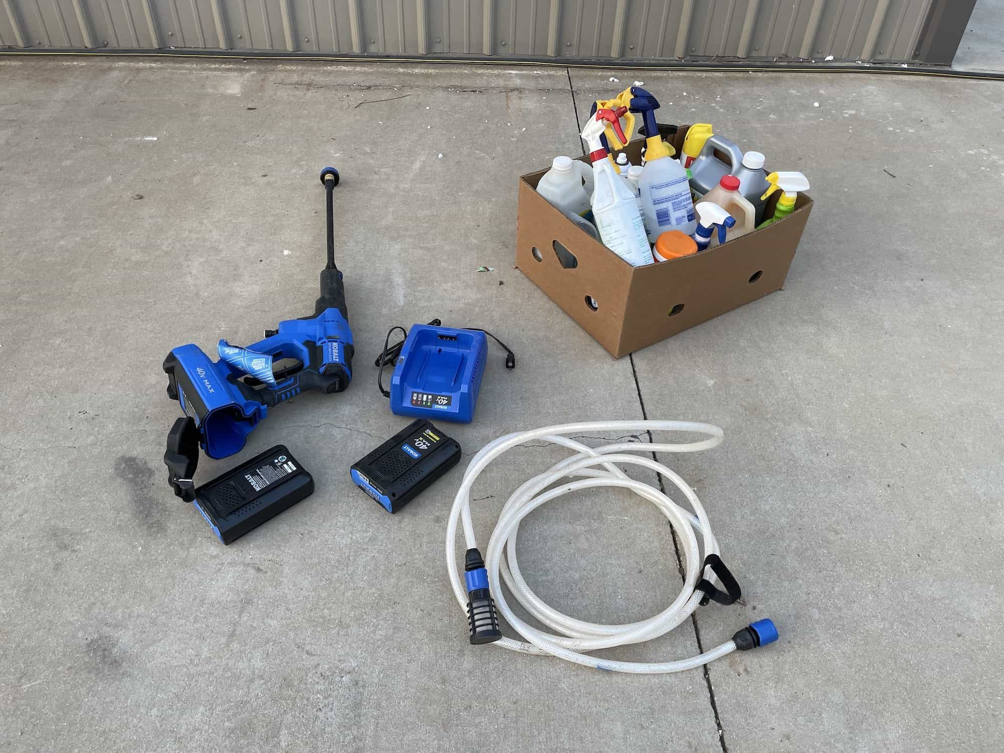 $50 - Kobalt Portable Pressure Washer w 2 batteries, charger, and box of cleaning supplies