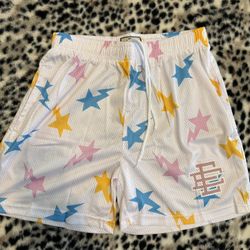 White bape EE shorts with blue, yellow and pink stars size medium
