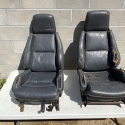 Chevrolet Corvette C4 (1984–1996) leather bucket seats. Based on the "CORVETTE" embroidery on the headrests and the power adjustment controls on the s