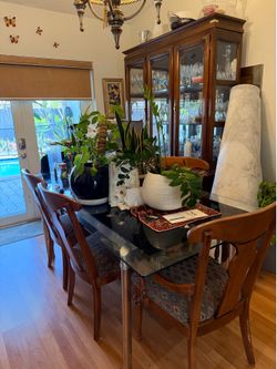 Glass dinning table and 6 wood chairs and hutch set