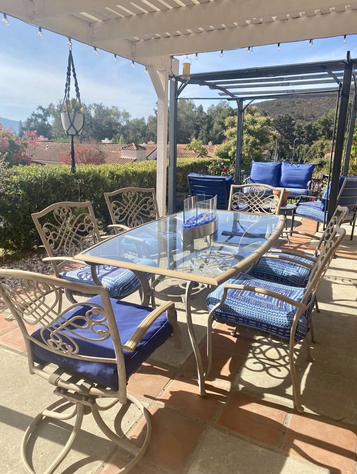 Tan Wrought Iron Glass Top Patio Table with 6 Chairs.