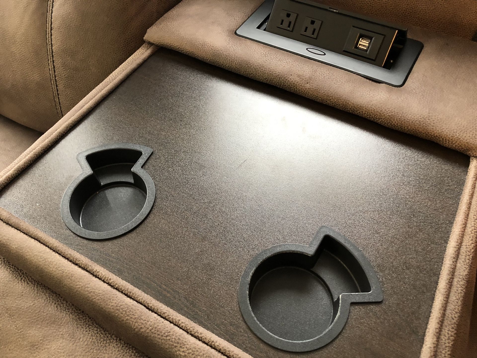 WATER RESISTANT Microfiber smooth bomber jacket material recliner. Pull out table with cup holders. Built in USB ports and wall plug ins. Hidden draw