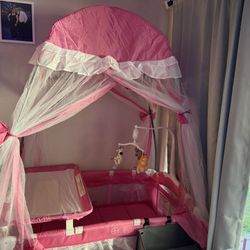 BABY JOY 4 in 1 Pack and Play with Canopy, Portable Baby Playard with Bassinet, Double-Layer Baby Crib, Wheels & Brake, Foldable Baby Girl Pink Bassin