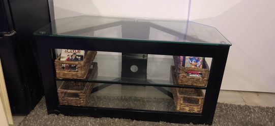 Glass entertainment center. 4 wicker baskets
