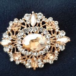 Elegant vintage look brooch adorned with crystals. 