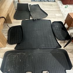 Tesla Model Y floor mats, seat back covers, and trunk bins with lids