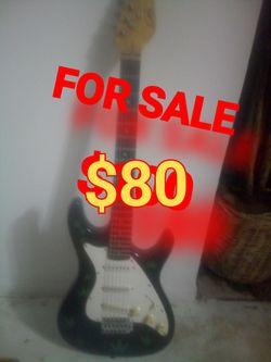 Black guitar with pot leaves on it$80