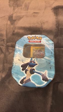 Unorganized tin of Pokémon cards