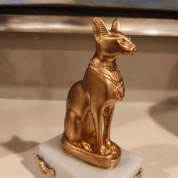 Gold Bastet Egyptian Cat on White Marble Pedestal