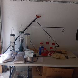 Large Assortment Of Bird Feeders And Feed