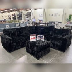Black corduroy sectional sofa with ottoman