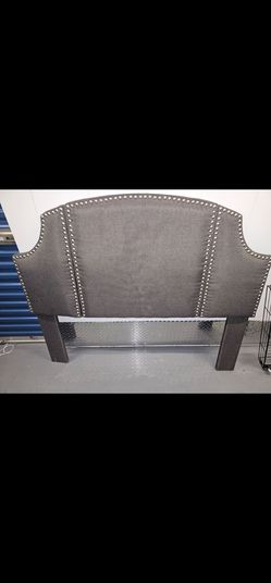 Gray upholstered headboard featuring nailhead trim detailing. It has a fabric finish and is approximately 62" or 157.5 cm wide.
MOD STORAGE Facility