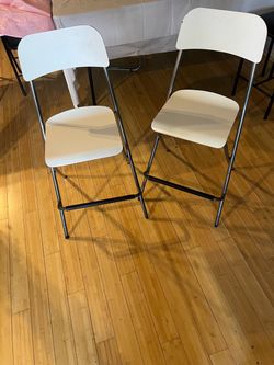 Two white folding chairs - heavy duty
