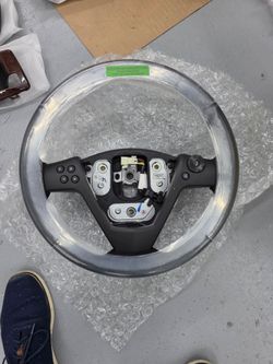 Brand new. 2003 to 2007 Cadillac CTS wood grain and leather steering wheel.