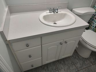 Vanity, countertop, sink, faucet, toilet paper holder, does have a little bit of corner damage,clean