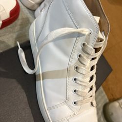 Christian Louboutin Louis model, recognizable by their signature red soles. 