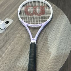 Women’s Wilson Soleste 105 Tennis Racquet in white and purple. 