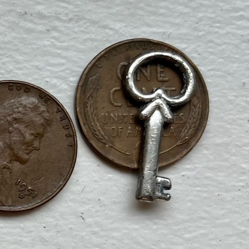 Tiny Silver Key Charm.