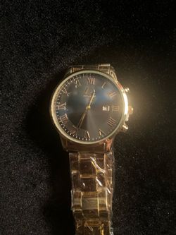 New gold men watch. Has black dial with multiple subdials. Watch has moon phase indicator. Metal link band is gold color. Protective film is on watch.
