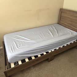 twin wooden bed frame and mattress