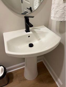 White Pedestal Sink with Black Faucet