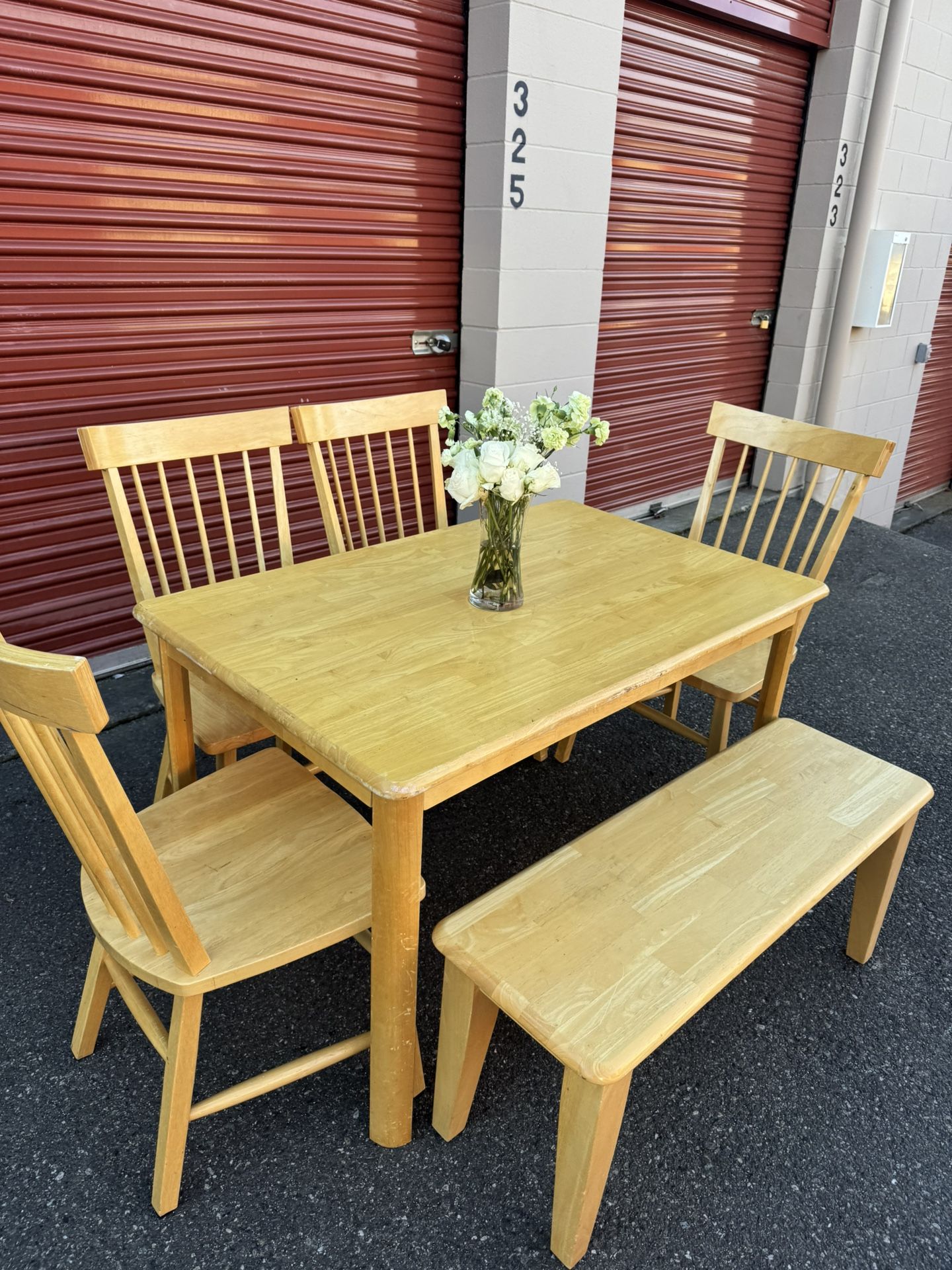 Wooden table and four chairs and a bench