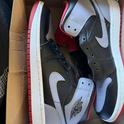 Black and white Air Jordan sneakers with red accents. Size 8  only one time in the house