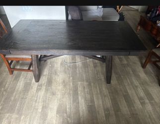 dining table features a rustic brown wood finish and a sturdy rectangular design. No Chairs