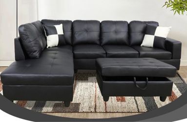 Black leather sectional couch and ottoman
