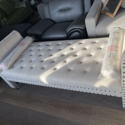 white tufted chaise lounge sofa with classic nailhead trim.