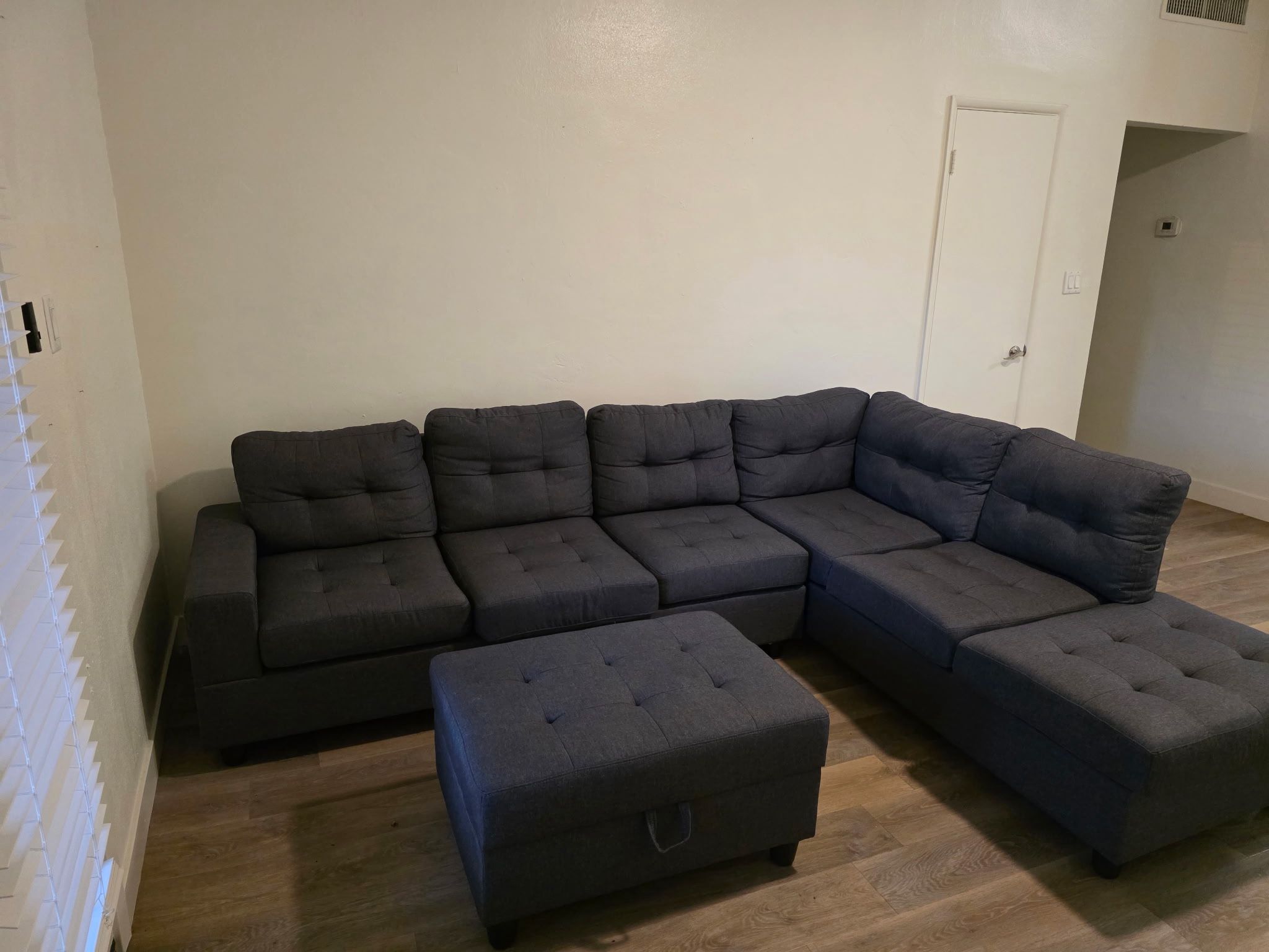 Gray sectional couch with Ottoman