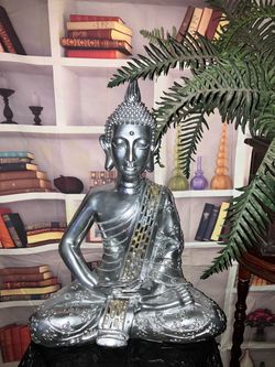 meditating silver buddha statue