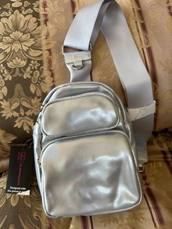 Brand new Hands Free Sling Handbag, Silver. $12 Or Best Offer