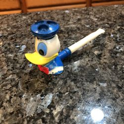 Vintage Disney Donald Duck Plastic Blowing Bubble Pipe.  Preowned.  Some of the plastic has turned yellow due to being very old.  The back of the head