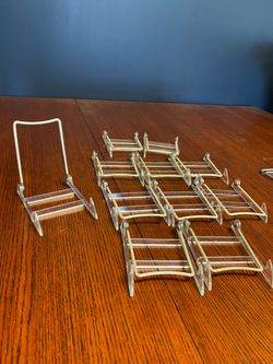 Adjustable Plate display Stands -  9 Pieces available  Plastic / acrylic stand, with hinge that is adjustable  2 more that are free due to broken clea