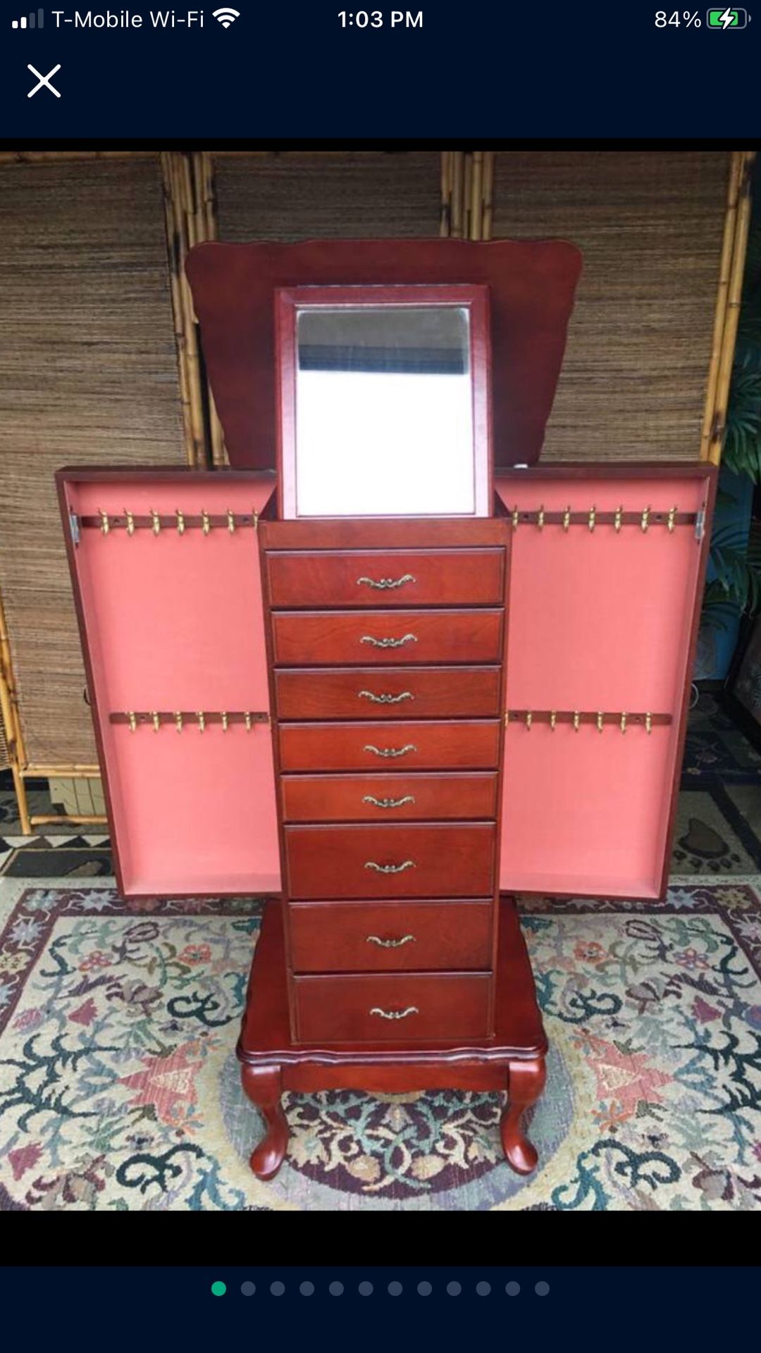 Burgundy Jewelry Armoire with Mirror , 8 drawers, Top compartment , and compartment doors on each side with several hooks inside. Pink Velvet linings.