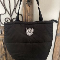 This is a black quilted puffer tote bag by Victoria's Secret PINK