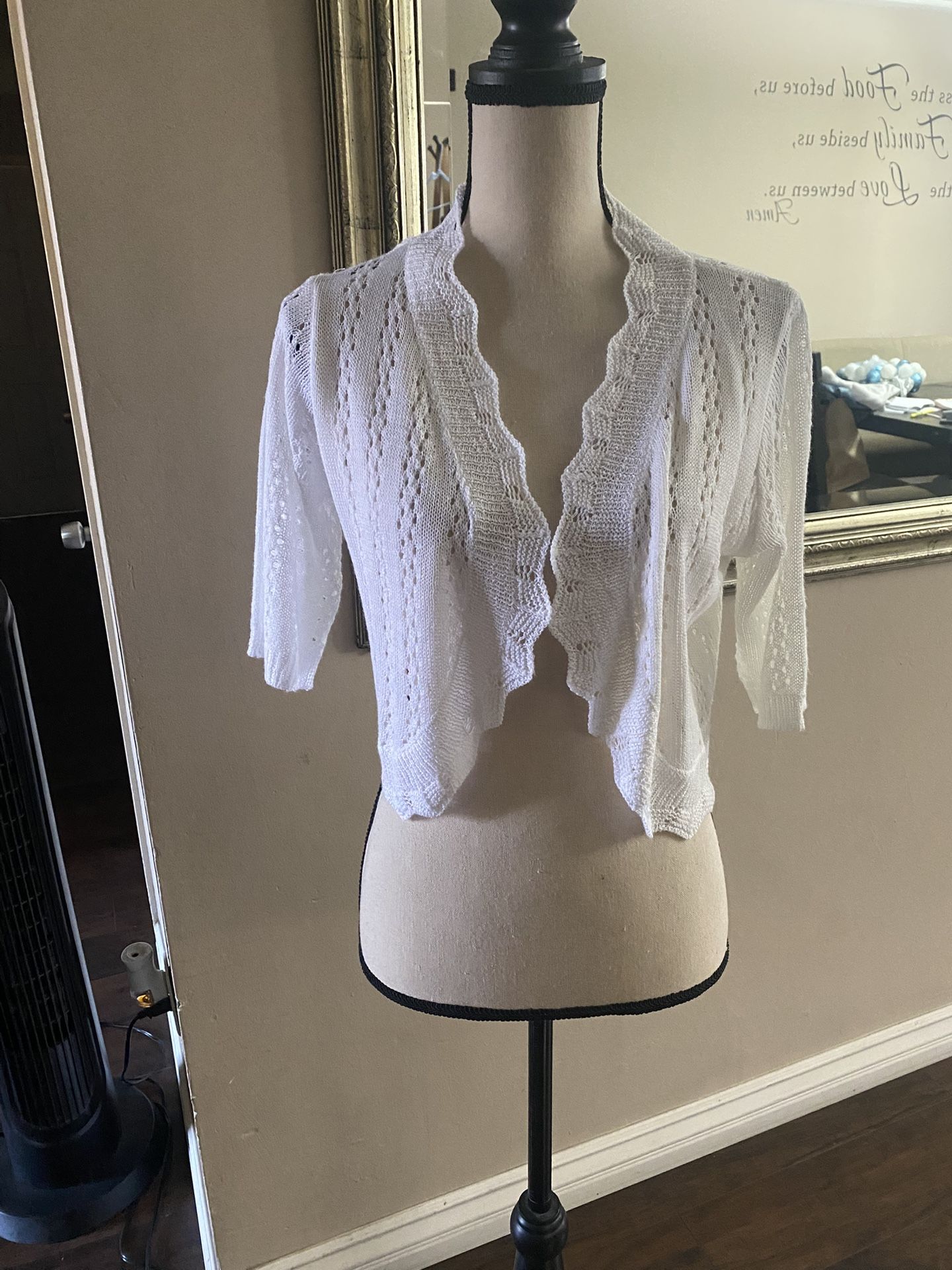 Women’s white, open-knit, cropped cardigan with a 3/4 length sleeves.