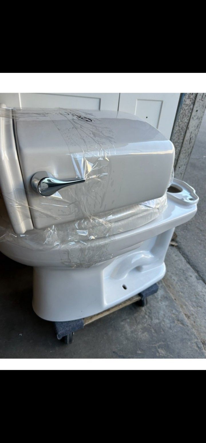 Brand new out of the box 2 piece ELONGATED TOTO TOILET WITH LEFT HAND LEVER SELLING EACH $180