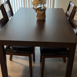 wooden dining table. 5ft by 3ft with 4 leather chairs