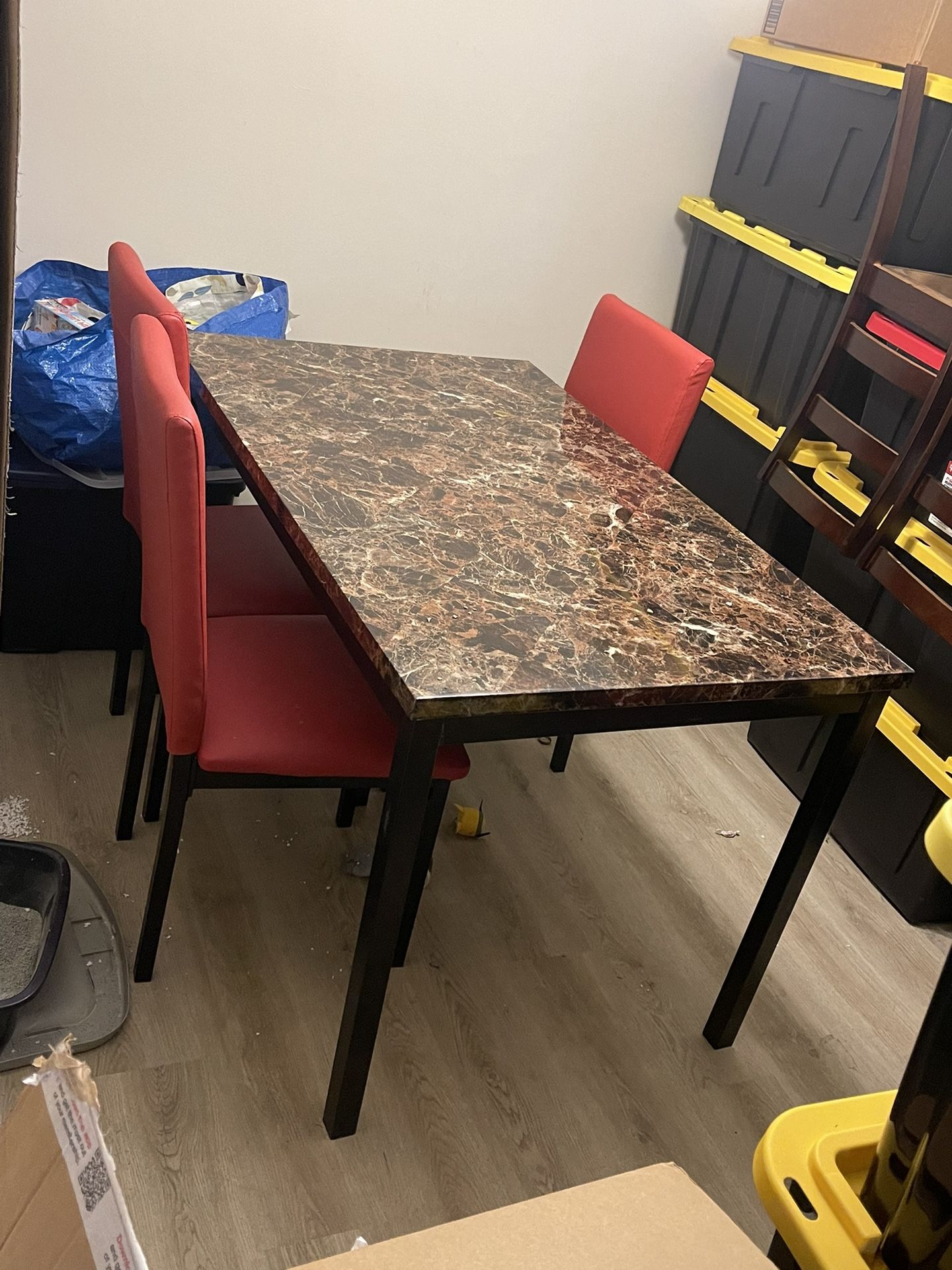 Table With Four Red Covered Chairs 