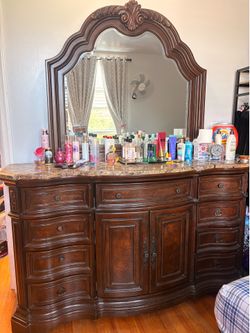 Wooden and marble dresser with mirror, in good condition.