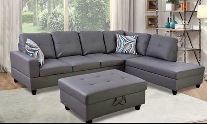 Gray leather sectional couch and ottoman