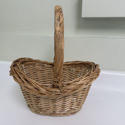 Small, thick wicker basket with handle. 