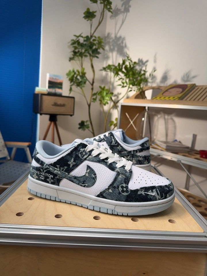 A pair of customized sneakers that combine the Nike Dunk Low silhouette with Louis Vuitton (LV) elements