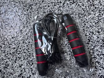 Gym-Jump rope with black and red foam-grip handles.