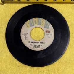 This item is a collectible vintage 7-inch vinyl record, specifically a 45 RPM single featuring the song "It Happened Today" by The Skyliners, released