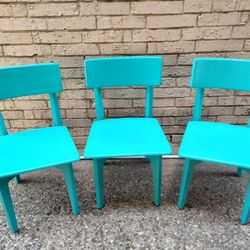 Three Wooden Teal Chairs