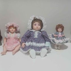 Porcelain dolls the middle one Is from 1996